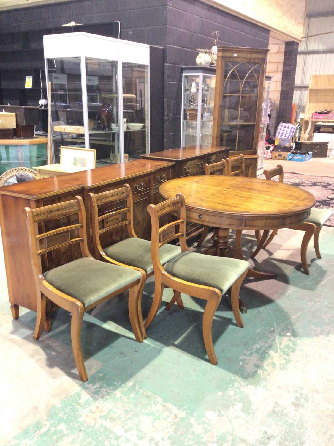 BEVAN FUNNELL; a reproduction yew wood dining room suite comprising circular extending table, six