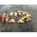 A group of predominantly yellow metal ear studs and earrings.