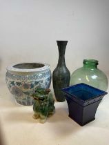 A green tinted glass carboy, a modern Chinese jardiniere, metal vase, Dog of Fo, and glass vase (