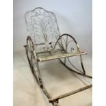 An unusual wrought iron garden rocking chair with sleigh style supports. Condition Report: There