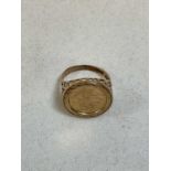 A 9ct yellow gold signet ring set with a coin dated 1949 and with pierced shoulders, size L. approx.