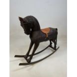 A small Continental rustic rocking horse with carved detail to the mane, length 68cms.