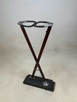 A vintage shooting stick now on an associated wooden plinth mounted as a display item, height 71cm.