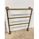 A vintage brass heated towel rail, width 80cm.