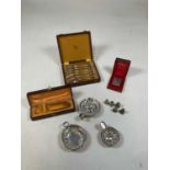 A group of silver plate including tastevins, thimbles, sugar tongs, etc, also spoons and a lighter.