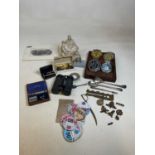A group of collectors' items including car badges, rosewood box, military cap badges, tax disc,