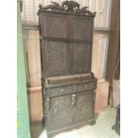 A late Victorian dark carved oak bookcase with ornate detail throughout, width 97cm.