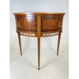 An Edwardian satinwood and crossbanded tambour fronted demi-lune side cabinet with pierced apron and