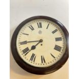An early 20th century stained mahogany wall clock, the painted dial set with Roman numerals and