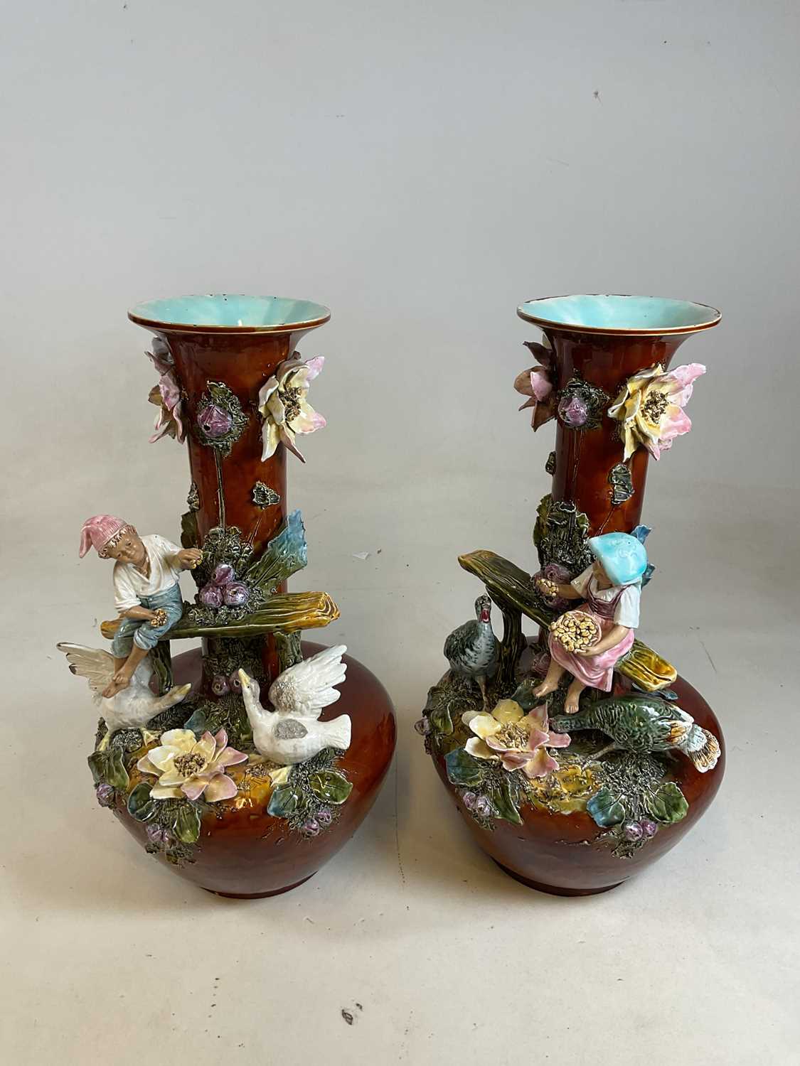 A large and impressive pair of late 19th century French majolica figural vases, height 53.5cm.