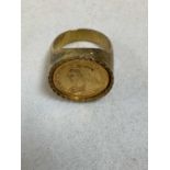 A yellow metal signet ring set with a coin depicting Queen Victoria, unmarked, size Q ½, approx.