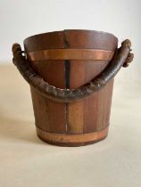 A vintage coopered wooden bucket with lift-out tin liner and rope twist handle, height 32cm.