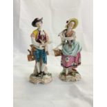 A pair of late 19th century Continental porcelain figures of a young gentleman and young woman, each