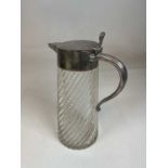 A large early 20th century wrythen moulded clear glass and silver plate mounted jug, the lid with