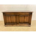 A mid 20th century oak linen fold decorated coffer, width 96 cm.