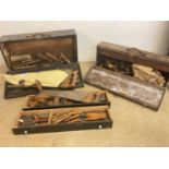 A vintage tool box including a drill, also another tool box and several saws.