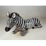 A large pottery figure of a recumbent zebra, length 80cm.