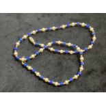 A lapis lazuli, cultured pearl and yellow metal bead necklace, length 40cm.