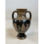 An unusual Etruscan inspired gilt heightened black ground twin handled vase and cover, unmarked,