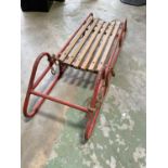 A vintage sled with wooden slats.