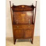 An Art Nouveau mahogany and inlaid bureau with two drawers above the fall front, segmented