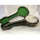 VEGA; a cased four string banjo with mother of pearl dot inlay to the fret, length 84cm.