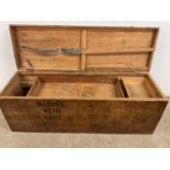 A large rustic pine chest with stencil detail to the lid and front and with simple carrying handle
