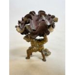 An unusual late 19th century bronze bonbon dish formed as twin upturned cherubs with a pair of