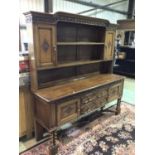 A 1930s oak dresser with carved detail, 180 x 50 x 187cm.