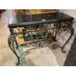 A contemporary wrought iron and marble topped side table with scrolling legs and elaborate carved