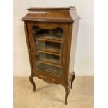 An Edwardian mahogany and floral marquetry inlaid display cabinet with glazed door and raised on