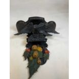 A painted and carved wall bracket set with an eagle above fruit 75cm h x 54cm W