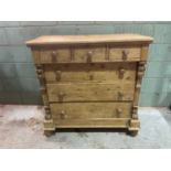 A 19th century Dutch pine chest of three short over three long drawers raised on bun feet, height