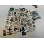 A group of contemporary and reproduction military cap badges, and a small group of buttons.