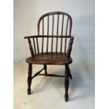 A 19th century child's ash and elm hoop back Windsor chair with saddle seat and ring turned front