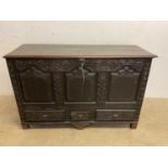 A metal lined 18th century carved oak blanket box with three drawers to the base, width 141cm.