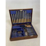 WALKER & HALL; a silver plated canteen of cutlery, set within a baize lined oak box.