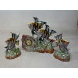 A Belgium 1950s mantel clock with garnitures in the form of a group of tropical fish, height 29cm.