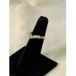 An 18ct yellow gold white metal tipped seven stone diamond wishbone ring, each stone weighing