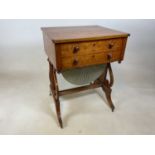 A Victorian bird's eye maple veneered crossbanded sewing table with two drawers above silk pleated