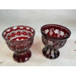 Two similar late 19th century Bohemian ruby tinted glass pedestal bowls, each with engraved