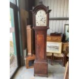 An early 19th century mahogany longcase clock with arched pediment above silvered dial inscribed '