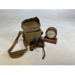 A pair of American issue Military binoculars in army issue case, dated 1943, and a clock