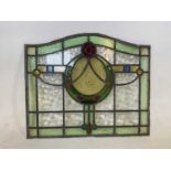 An Arts & Crafts stained glass panel, height 50cm, width 60cm.