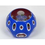 PERTHSHIRE; a triple overlay paperweight containing a spray of blue and white flowers over pink,