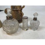 A cut glass globular perfume bottle with silver collar, two further silver mounted cut glass