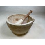An early 20th century ceramic pestle and mortar, 'Made in England 11' impressed to the base, beech