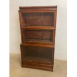 GLOBE WERNICKE; a three tiered stacking bookcase with glazed doors and plinth base, all three