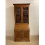 An Edwardian mahogany and inlaid bureau bookcase with leaded glazed upper section and base with fall