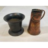 A cast iron mortar, height 14cm and an Arts and Crafts copper jug, height 19cm.